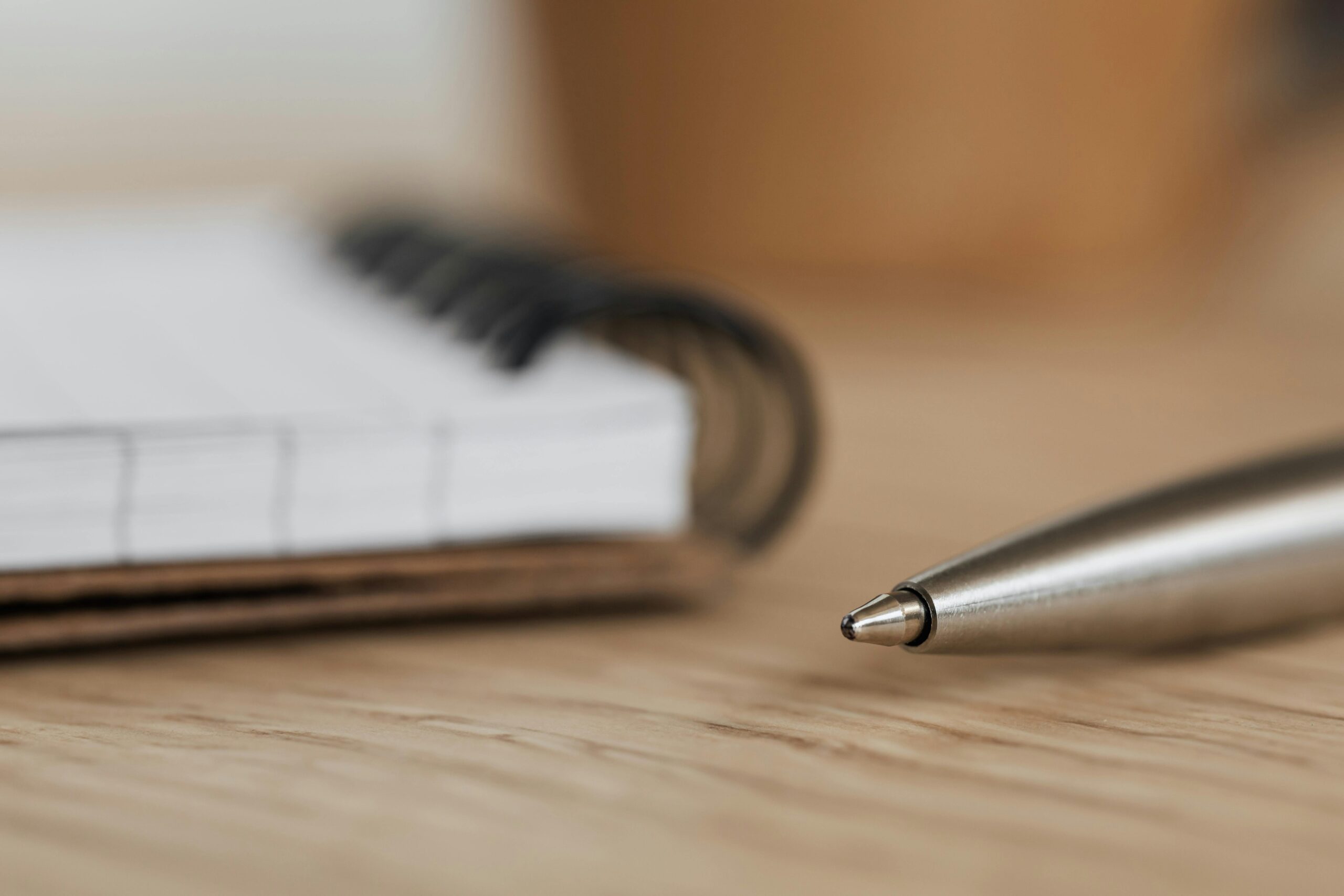 A desk, notebook, and pen utilized to document medication interactions and choose pharmacological interventions for mental health